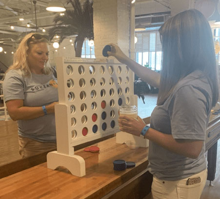 Team members Jaramee and Janet playing a game of connect 4